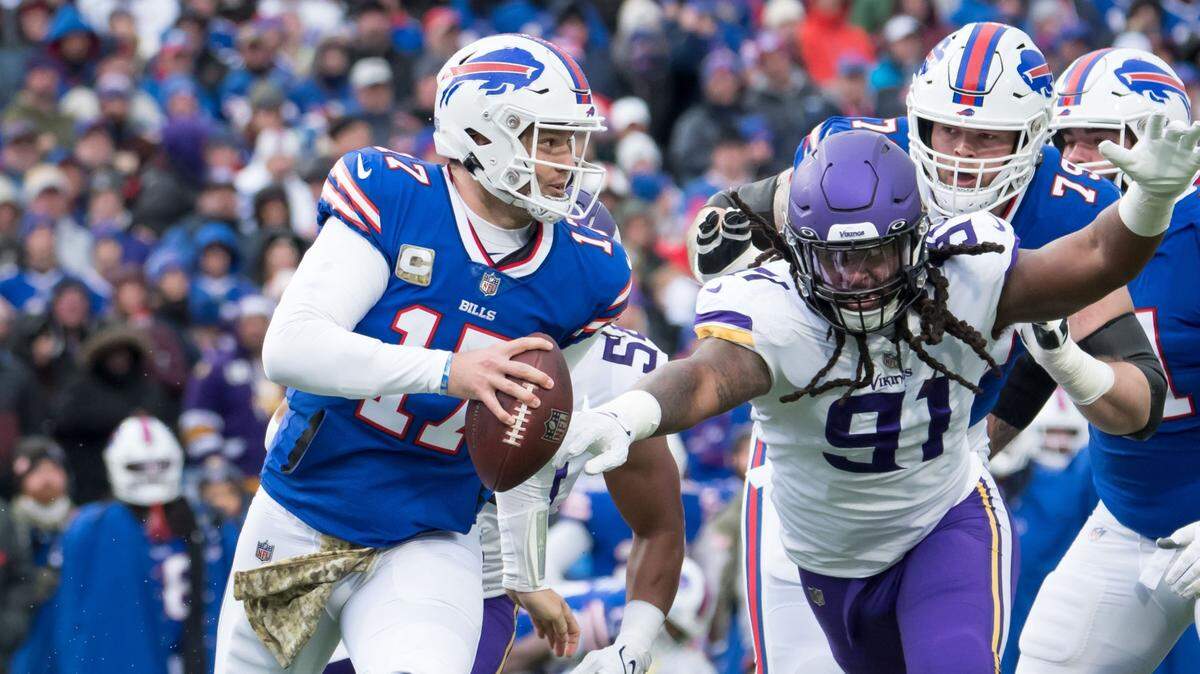 Nov 13, 2022; Orchard Park, New York, USA; Buffalo Bills quarterback Josh Allen (17) runs from Minnesota Vikings linebacker Patrick Jones II (91) in the second quarter at Highmark Stadium. Mandatory Credit: Mark Konezny-USA TODAY Sports