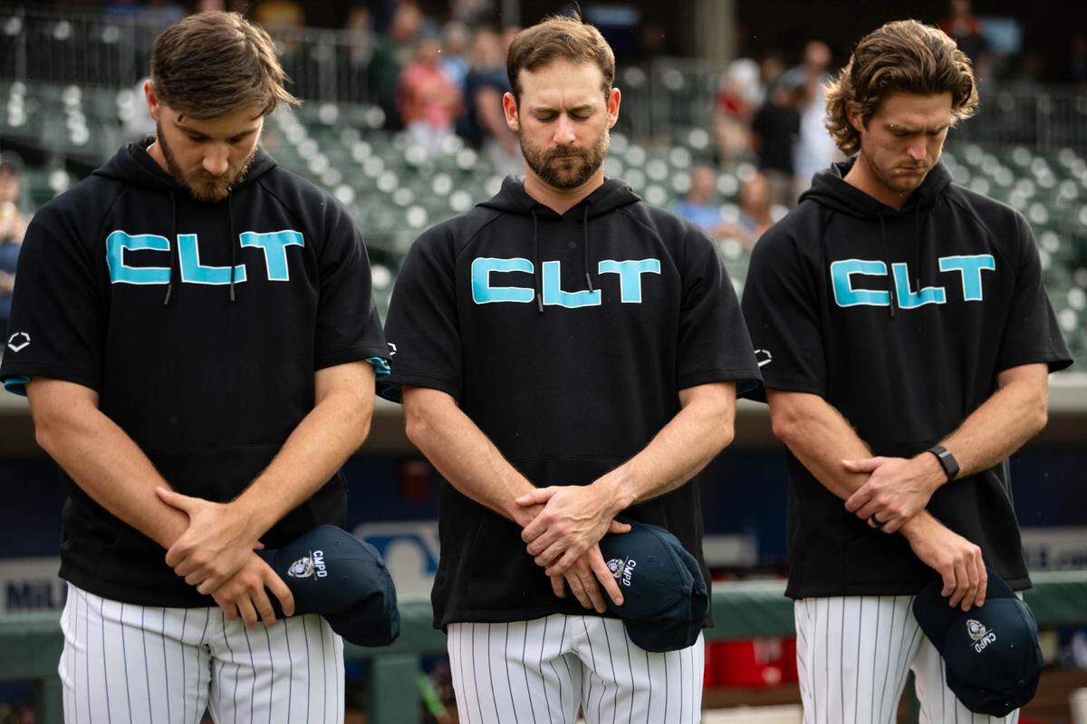 A moment of silence for law officers who were killed on Monday, April 29, 2024 in east Charlotte took place before the 6:05 p.m. game between the Charlotte Knights and Memphis Redbirds at Truist Field.