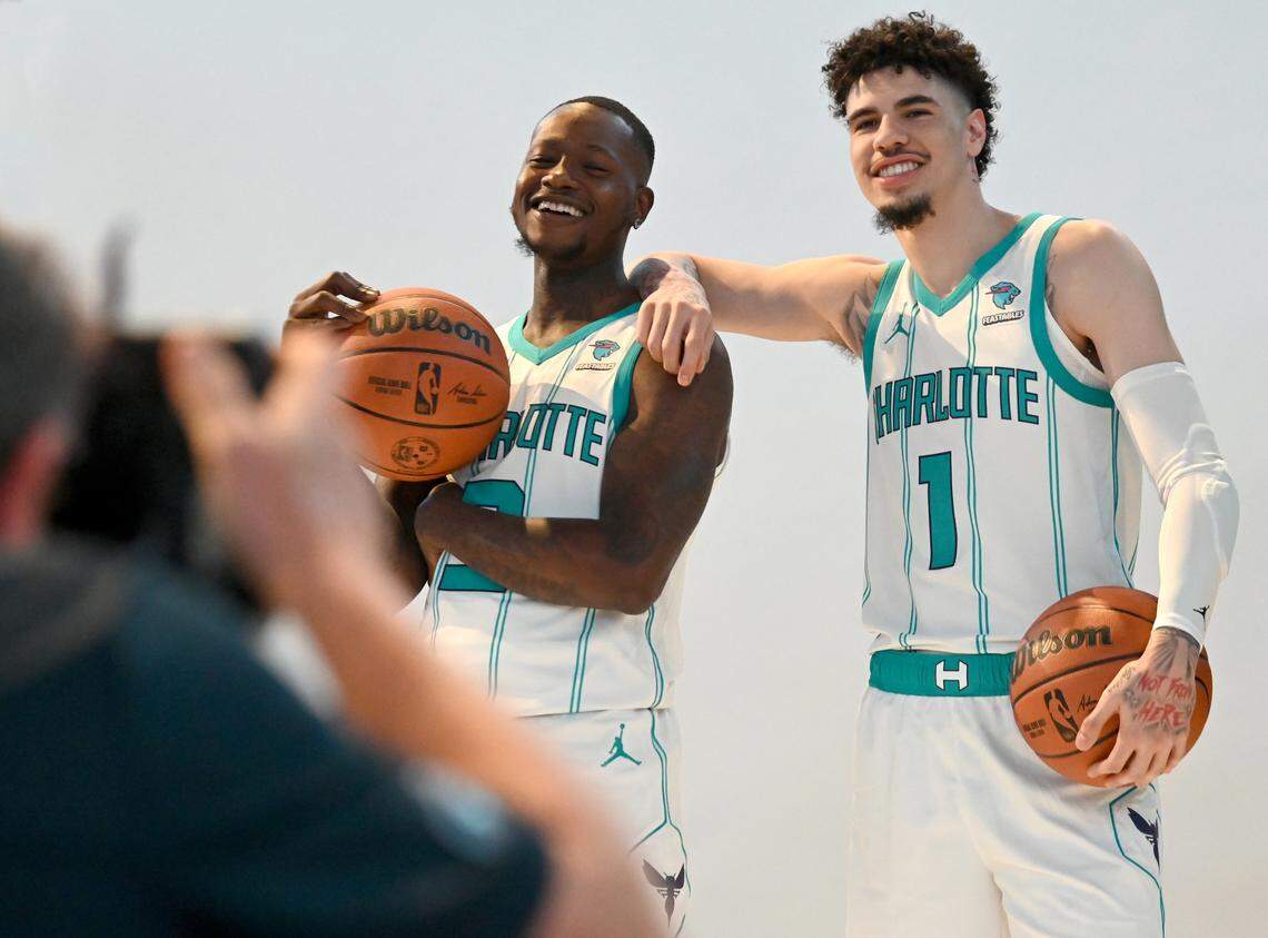 NBAE photographer Kent Smith, left, photographs Charlotte Hornets guards Terry Rozier, left and LaMelo Ball, right, during the team’s media day on Monday, October 2, 2023 at Spectrum Center in Charlotte, NC.