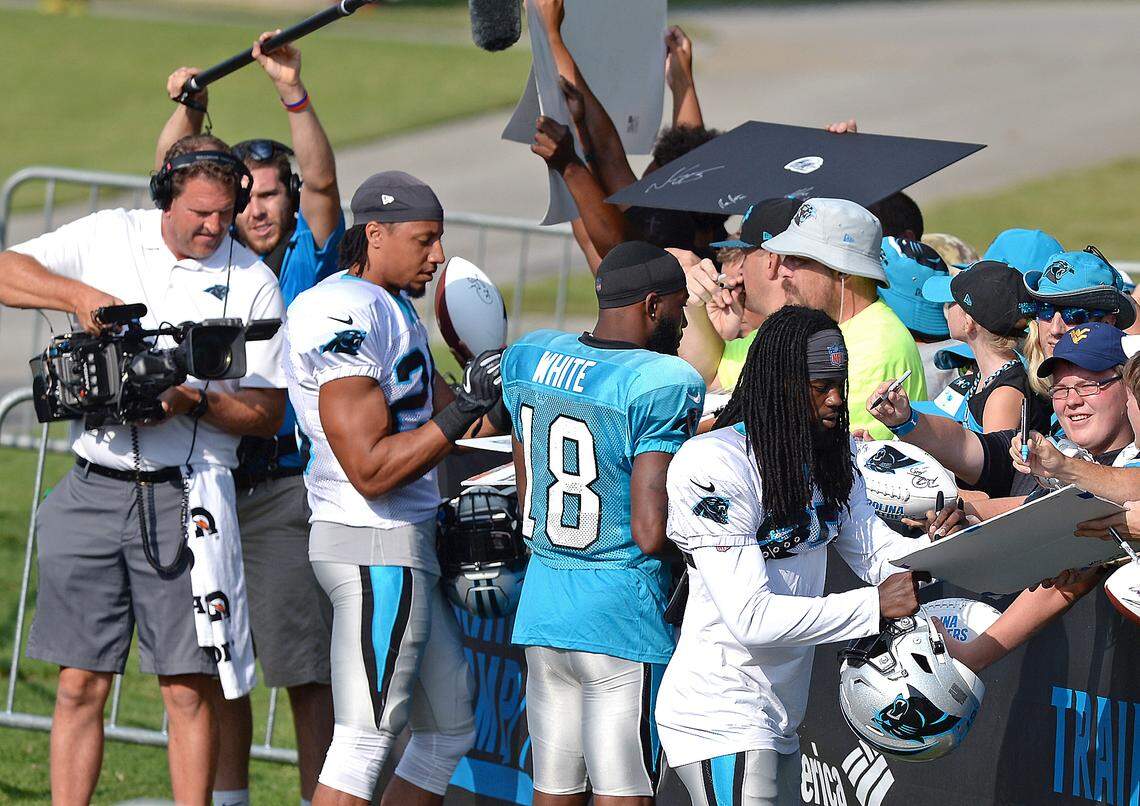 Carolina Panthers safety Eric Reid, left, stops to sign autographs for fans along with wide receiver DeAndrew White, center and cornerback Donte Jackson prior to practice on Sunday, July 28, 2019 at Wofford College in Spartanburg, SC.