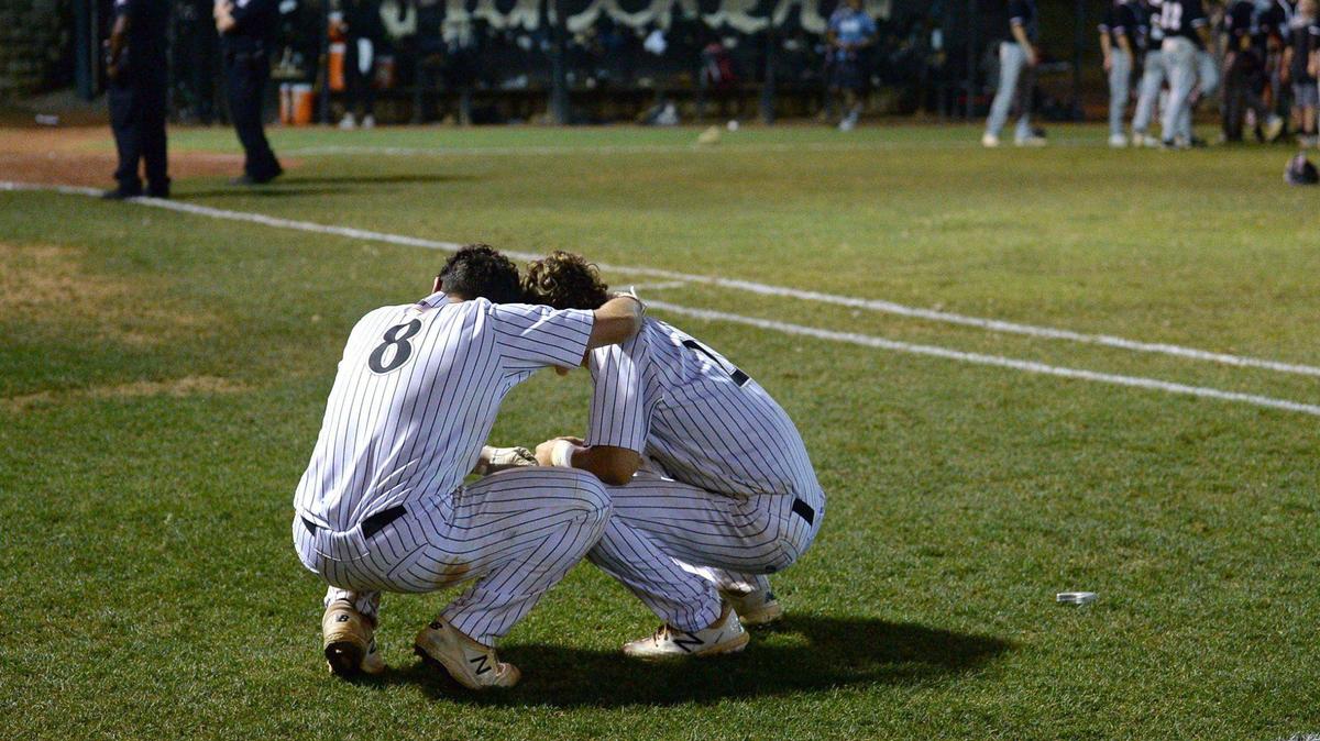 Providence HighÕs Luke Woolf, left and Jacob Russak, right, console one another following the teamÕs loss to Reagan High in NC 4A state semifinals action on Tuesday, June 22, 2021. Reagan High defeated Providence 7-3.