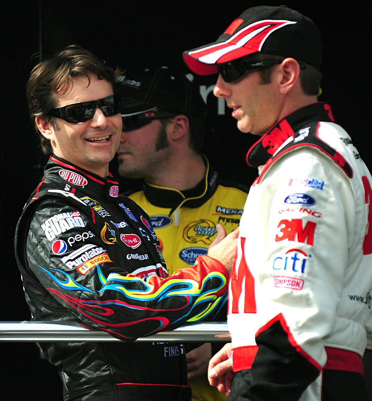 NASCAR driver Jeff Gordon, left, talks with driver Greg Biffle prior to the first Gatorade Duel race at Daytona International Speedway in Daytona Beach, Florida, Thursday, February 12, 2009.