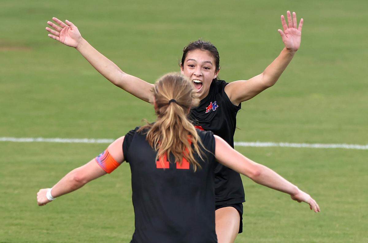Marvin Ridge’s Lucy Chin, facing camera, celebrates her goal with teammate Camryn McKee during first half action of the NCHSAA 4A state final game against Wilmington Ashley at the Matthews Sportsplex in Matthews on Friday, May 31, 2024.