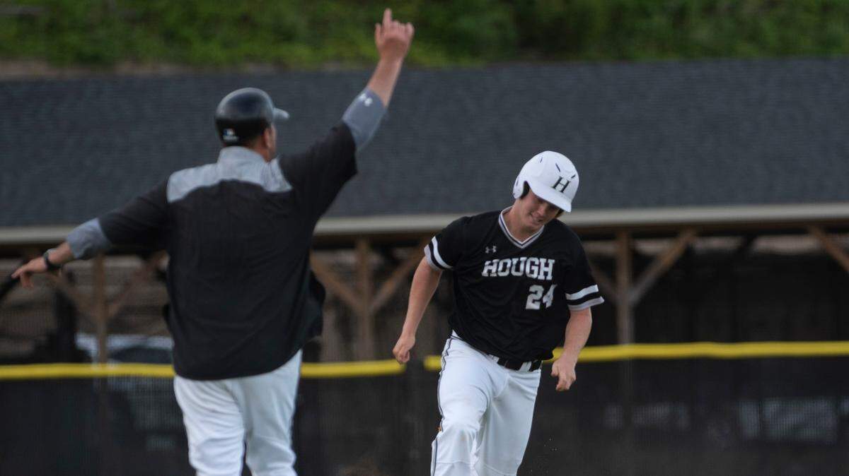 Hough High school batter Dylan Koontz gets the signal to round third base after a deep hit by Hough. The Huskies defeated the Vance Vipers 10-0 in 5 innings to finish the season 14-0 on June 11, 2021 at Hough High School.