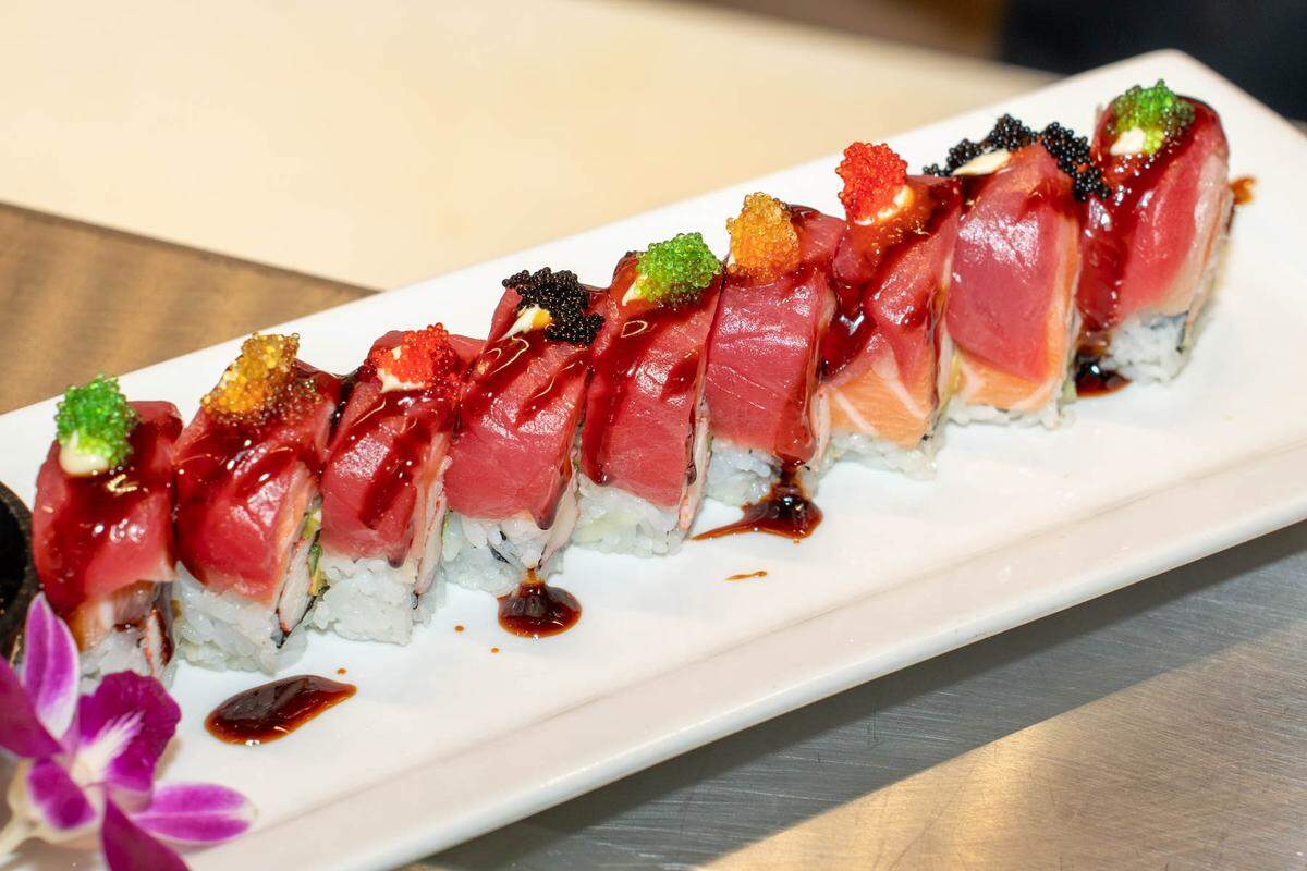 EeZ’s Tropical Storm Roll has kani, avocado and cucumber, topped with tuna, salmon, yellowtail, Japanese mayo, sweet eel sauce, sriracha and tobiko. It comes with a side of wasabi yuzu.