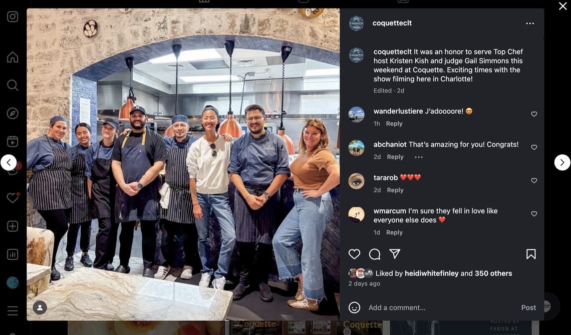 The image in the post shows a group of eight restaurant staff members smiling and posing for a photo in a professional kitchen, which is set under a rustic stone archway. The post’s caption reads: “It was an honor to serve Top Chef host Kristen Kish and judge Gail Simmons this weekend at Coquette. Exciting times with the show filming here in Charlotte!”