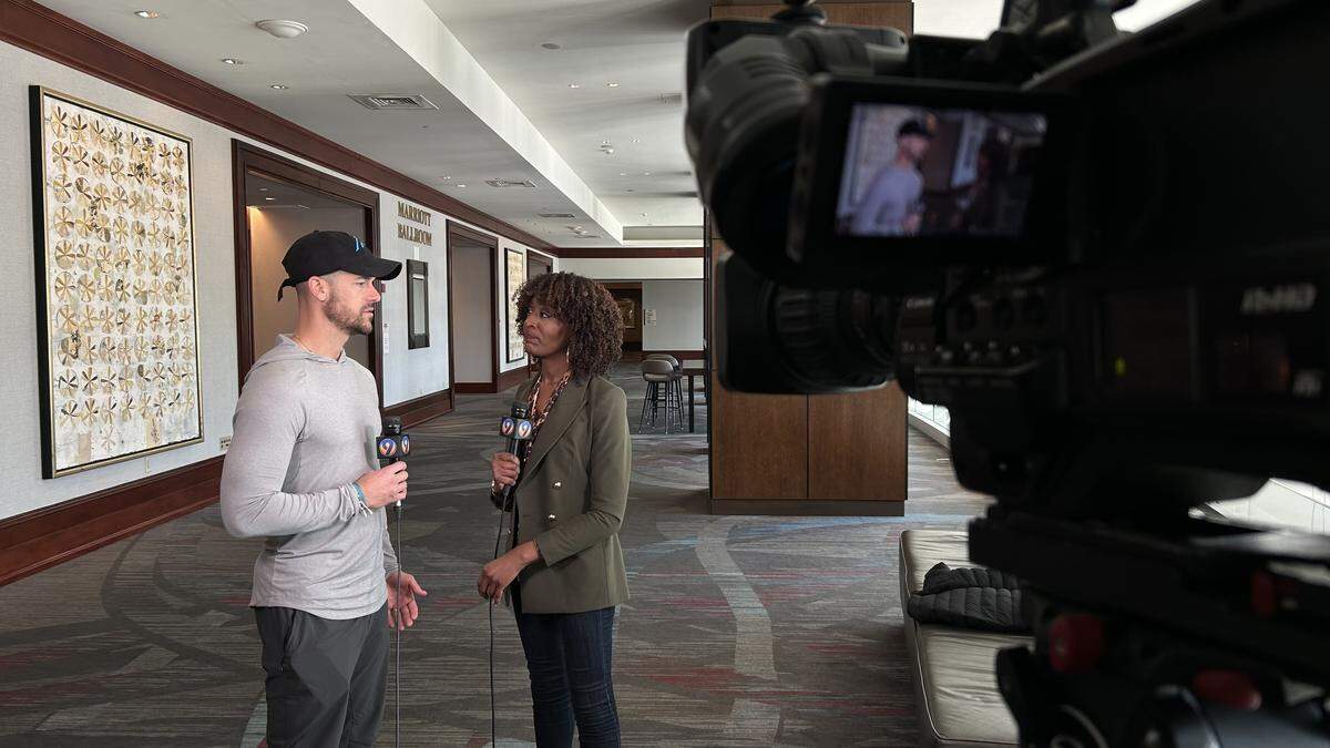 WSOC-TV sports reporter DaShawn Brown (right) interviews Carolina Panthers head coach Dave Canales in 2024 at the NFL scouting combine in Indianapolis.