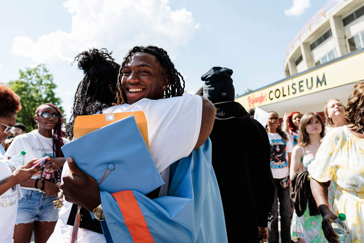 Rashard Stewart hugs his grandma, Lisa Cunningham, after graduating from Ballantyne Ride High School at the Bojangles Coliseum on Saturday. “I don’t want to let him go,” Cunningham said. “He’s a good, good boy.”