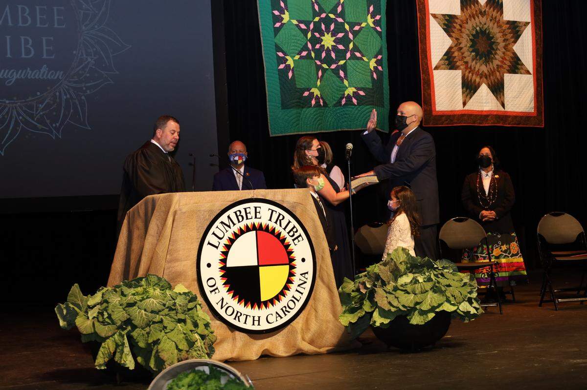 John Lowery, right, takes the oath of office as chairman of the Lumbee Tribe of North Carolina during an inauguration ceremony at UNC-Pembroke on Thursday, Jan. 6, 2022.