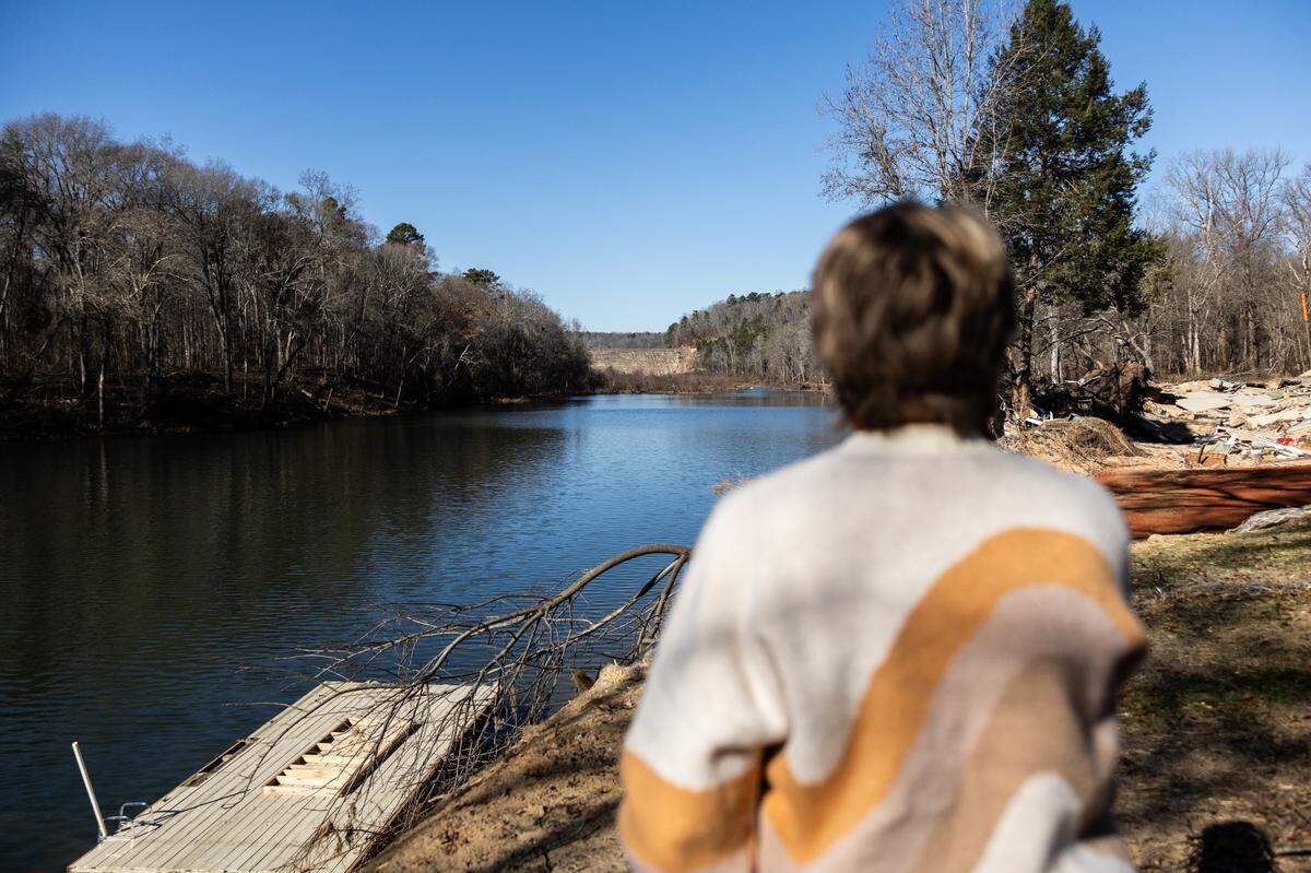 Betsy Patton looks out at the Mountain Island Lake spillway last month from her backyard on Riverhaven Drive in Charlotte.