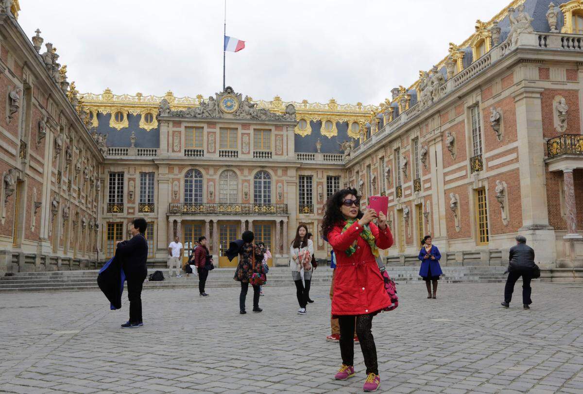 FILE - In this Nov.17, 2015 file photo, visitors take photos at the Versailles castle, in Versailles, west of Paris. The Palace of Versailles, one of France’s top tourist attractions, and the Orsay museum in Paris were closed to visitors on Tuesday June 19, 2018 due to a strike of employees. (AP Photo/Amr Nabil, File)
