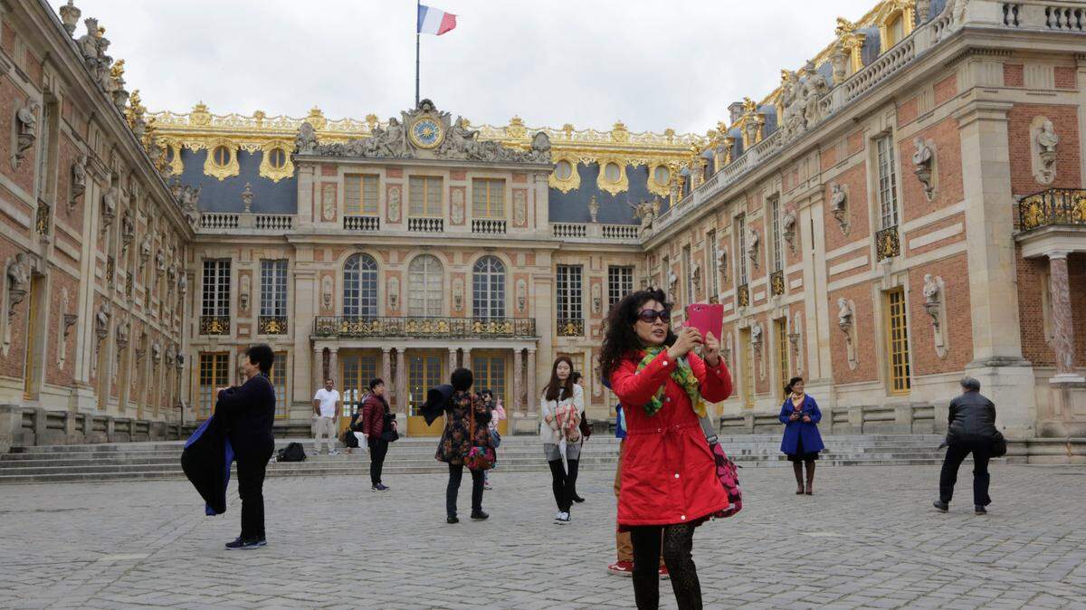 FILE - In this Nov.17, 2015 file photo, visitors take photos at the Versailles castle, in Versailles, west of Paris. The Palace of Versailles, one of France’s top tourist attractions, and the Orsay museum in Paris were closed to visitors on Tuesday June 19, 2018 due to a strike of employees. (AP Photo/Amr Nabil, File)