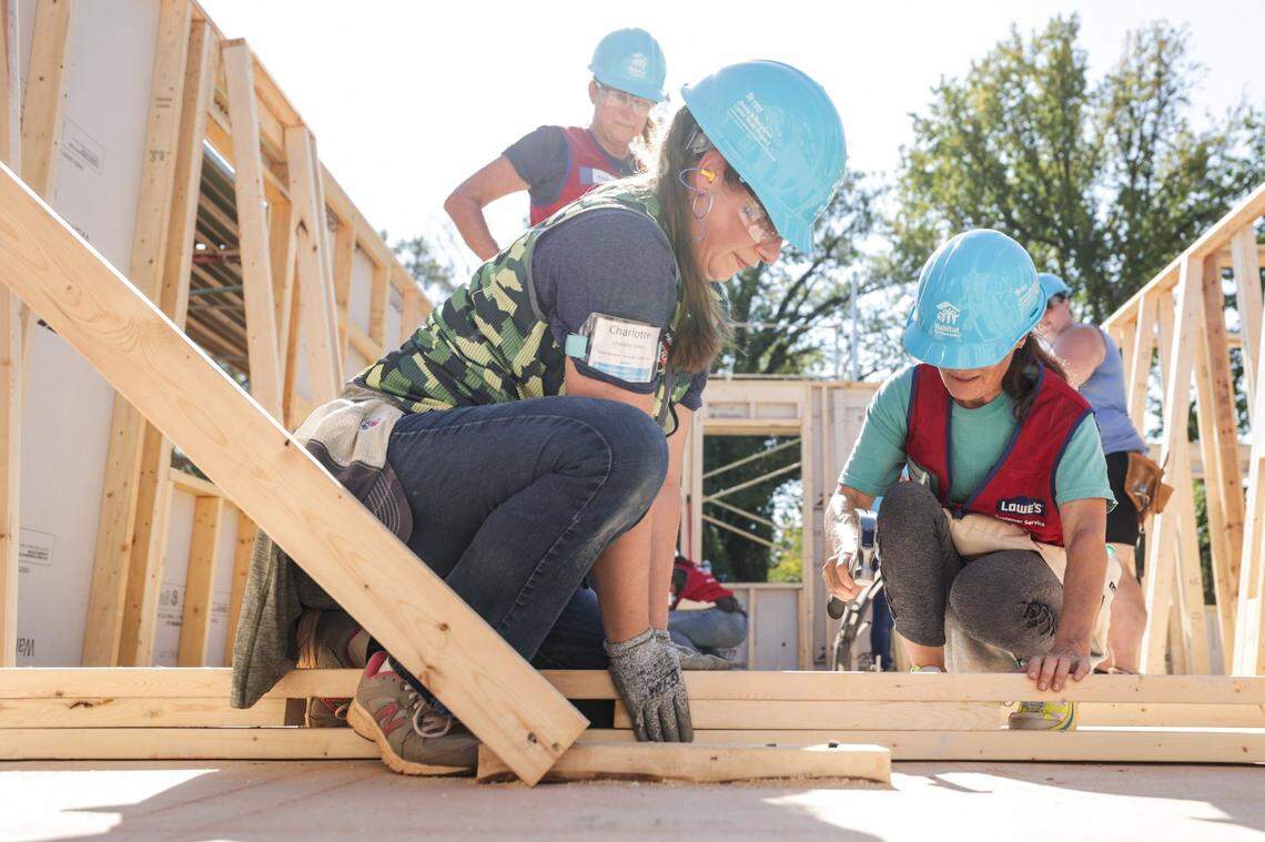 Volunteers work on a home for the 2023 Jimmy & Rosalynn Carter Work Project in the Meadows at Plato Price development in October. A variety of housing programs are available for residents in the Charlotte region, especially for first-time homeowners.