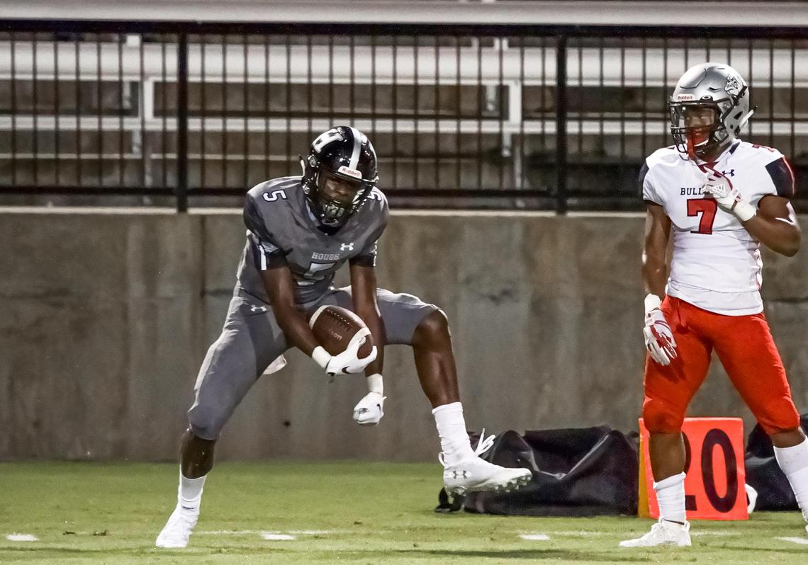 Hough’s Devin Chandler (leff) celebrates his big catch. Chandler spent his senior season in 2019 at Hough High School in Huntersville and became one of the best receivers in North Carolina. He then went on to play for Wisconsin before transferring to the University of Virginia. He was one of three victims killed in a shooting on UVA’s campus Sunday, Nov. 13, 2022.