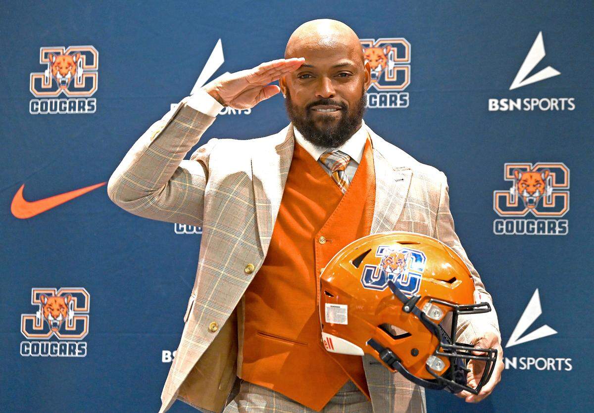 Former Carolina Panthers cornerback Captain Munnerlyn gives his signature salute after being introduced as the new head football coach at Julius Chambers High School in Charlotte, NC on Friday, January 24, 2025. 