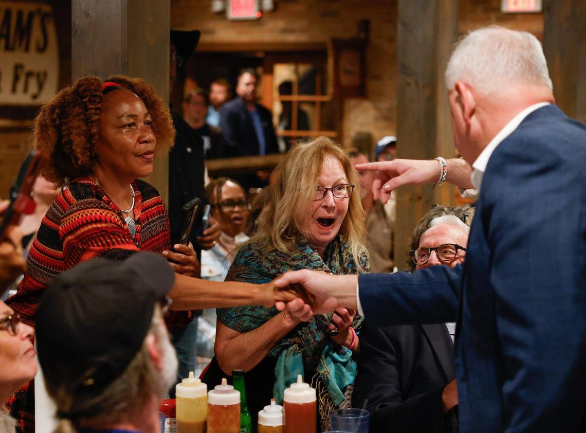 Gov. Tim Walz shakes hands with supporters at RayNathan’s Sunday.