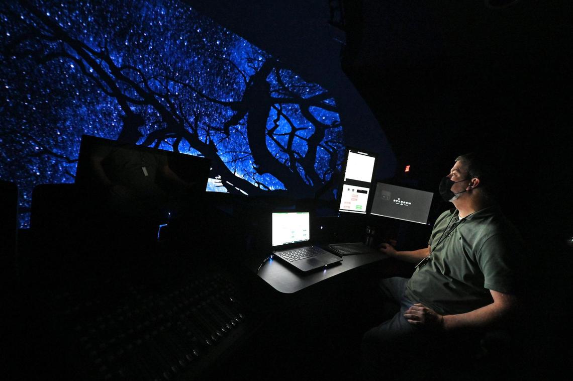 Brian Hester, director of theater operations at Discovery Place in Charlotte, watches an IMAX movie preview in the IMAX Dome Theatre.