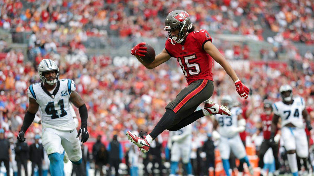 Tampa Bay Buccaneers wide receiver Jalen McMillan (15) leaps into the end zone for a touchdown against the Carolina Panthers in the fourth quarter at Raymond James Stadium in Tampa Sunday. Tampa Bay won, 48-14.