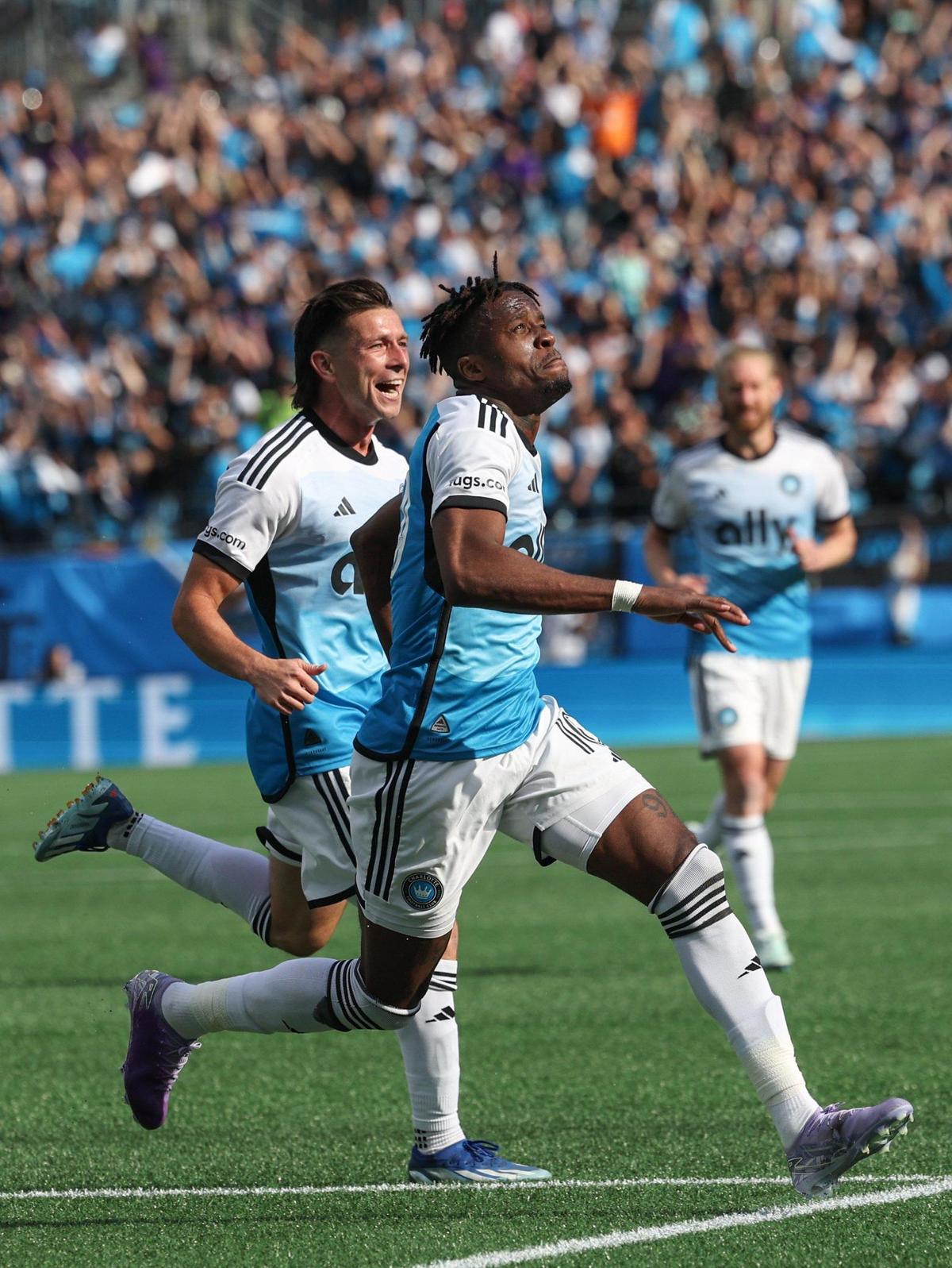 Charlotte FC’s Wilfried Zaha (center) celebrates with teammates after scoring a goal in the 54th minute Saturday during the match against Atlanta United at Bank of America Stadium. Charlotte FC won, 2-0, in Zaha’s Major League Soccer debut.