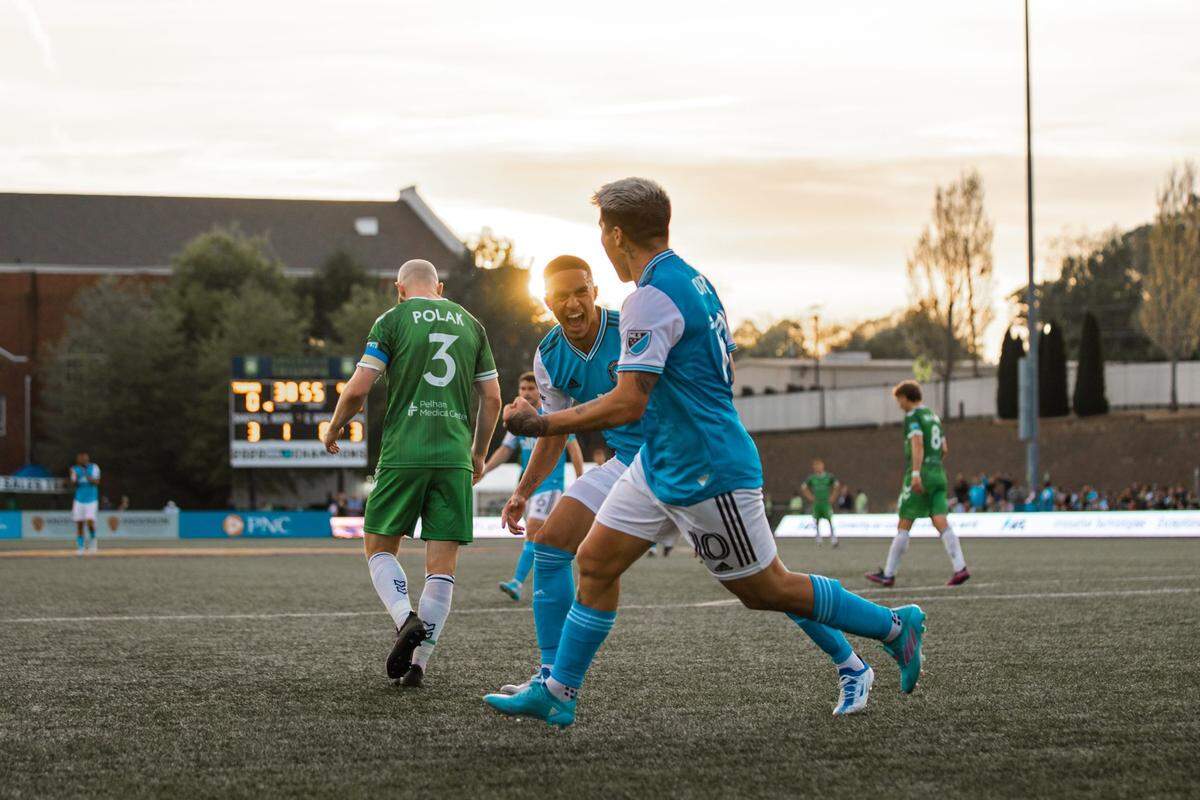 Charlotte FC defender Adam Armour, center, celebrates with midfielder Titi Ortiz after Ortiz scored a goal against the Greenville Triumph in the U.S. Open Cup in Greenville, S.C., on Wednesday.