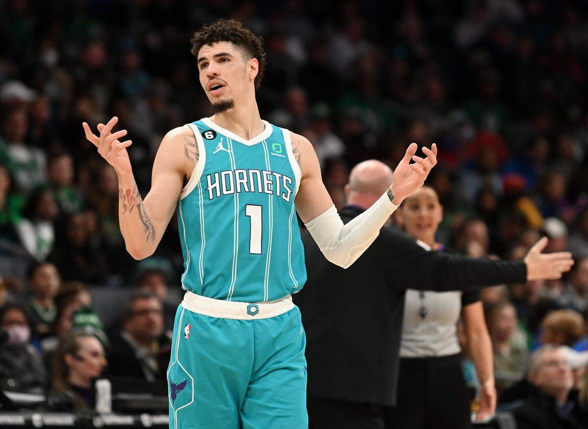 Charlotte Hornets guard LaMelo Ball throws up his hands as head coach Steve Clifford questions a call with referee Ashley Moyer-Gleich in the background during second half action against the Boston Celtics at Spectrum Center in Charlotte, NC on Monday, January 16, 2023. The Celtics defeated the Hornets 130-118.