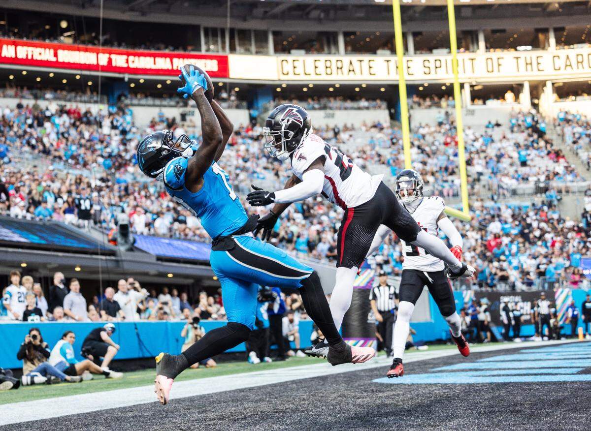 Carolina Panthers wide receiver Xavier Legette scores a touchdown past Atlanta Falcons safety DeMarcco Hellams at the Bank of America Stadium in Charlotte, N.C. on Sunday, October 13, 2024.