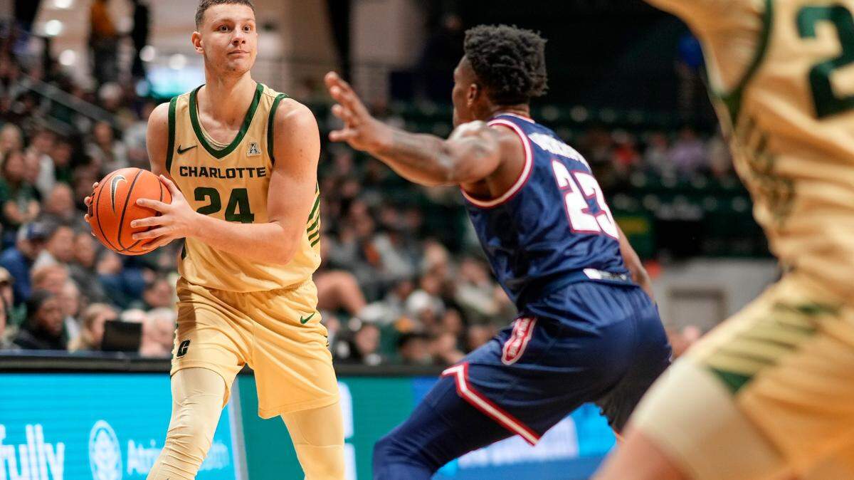 Charlotte 49ers forward Igor Milicic Jr. (24) looks to pass around Florida Atlantic Owls guard Brandon Weatherspoon (23) during the first half on Jan. 6 at Dale F. Halton Arena in Charlotte, N.C.