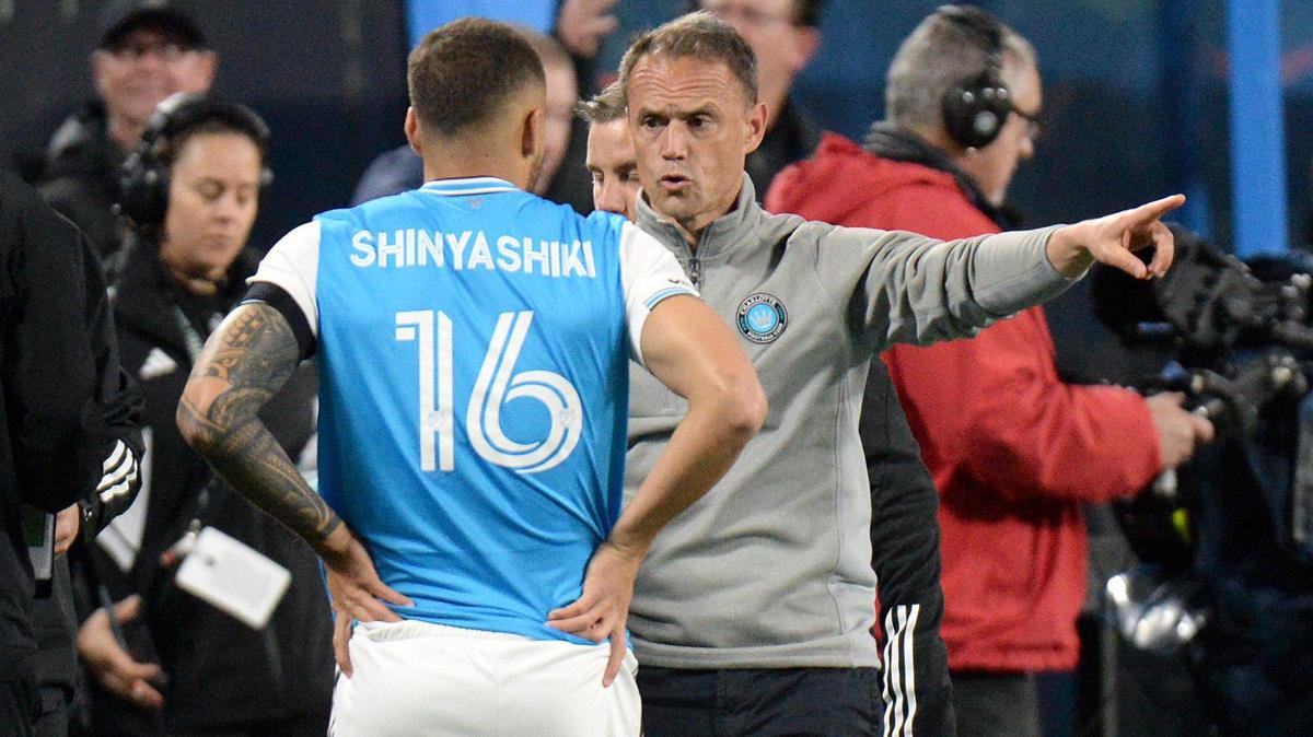 Charlotte FC’s #16, Andre Shinyashiki gets some instructions from head coach, Christian Lattanzio, prior to him being inserted into the match during the second half. Charlotte lost to the New England Revolution 1-0. Charlotte FC faced off against the New England Revolution in the season opener at Bank of America Stadium during a Saturday evening game on Feb. 25, 2023.