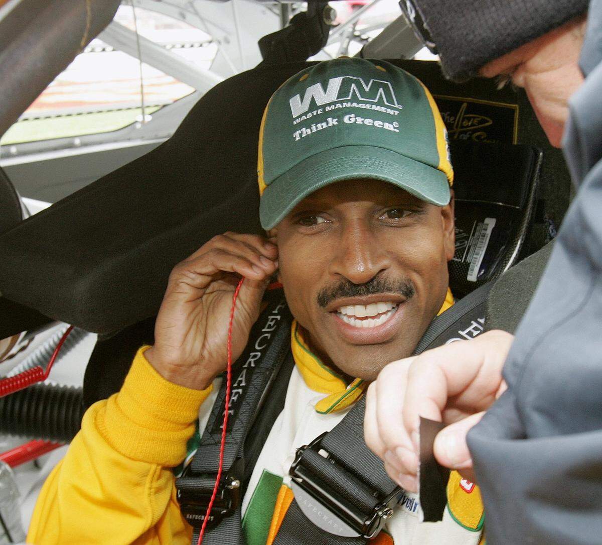FILE - NASCAR driver Bill Lester gets ready for a rain delayed start of the NASCAR Golden Corral 500 auto race at Atlanta Motor Speedway, in Hampton, Ga., in this Monday, March 20, 2006, file photo. Bill Lester, one of the first Black drivers to compete in NASCAR’s Truck Series, will return to competition 14 years after his last start. Lester will drive for David Gilliland Racing on Saturday, March 20, 2021, in the Truck Series race at Atlanta Motor Speedway. It will be the first NASCAR start for the 60-year-old since 2007. (AP Photo/Ric Feld, File)