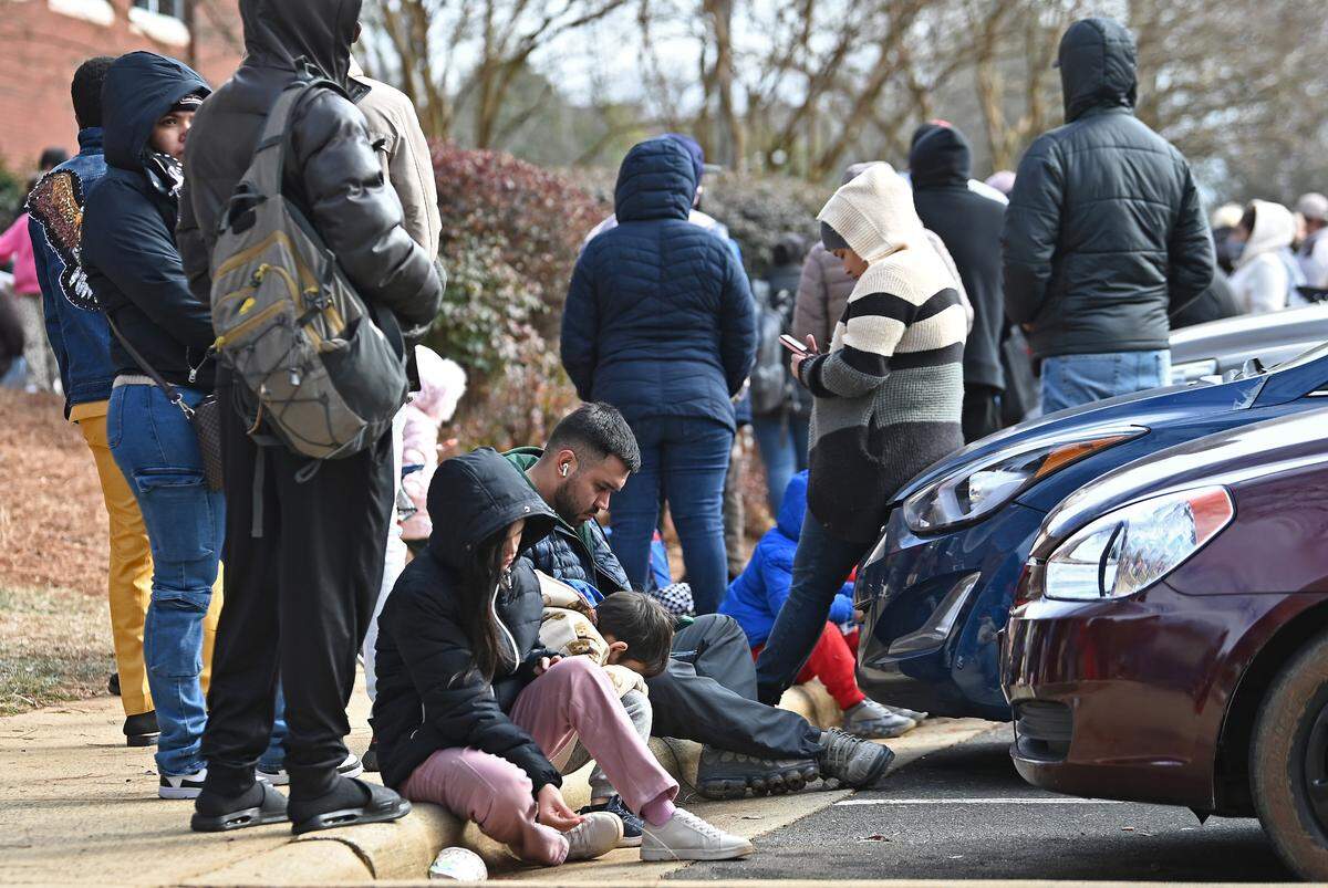 People wait outside the U.S. Department of Homeland Security office in Charlotte, NC on Thursday, January 16, 2025.