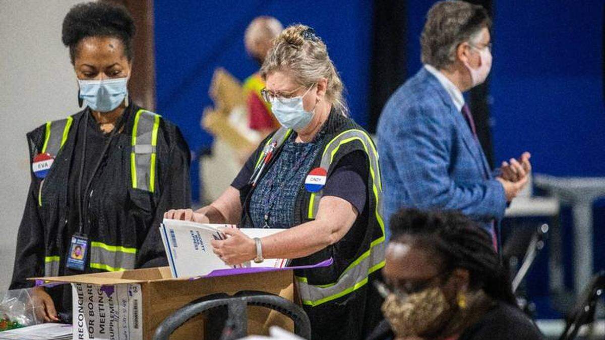 Election workers process absentee ballots Tuesday, Nov. 10, 2020 at the Wake County Board of Elections Operations Center in Raleigh. TRAVIS LONG TLONG@NEWSOBSERVER.COM