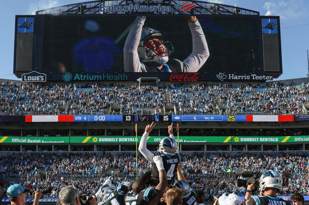 Carolina Panthers place kicker Eddy Pineiro, center, is hoisted by his teammates after making the winning field goal against the Texans at Bank of America Stadium on Sunday, October 29, 2023. The Panthers beat the Texans, 15-13.
