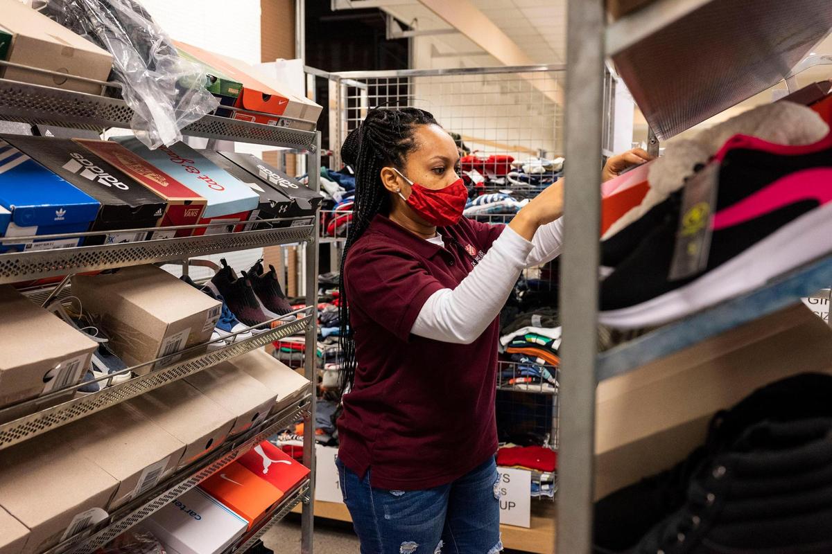 Glenisha Thomas, an employee of Salvation Army, helps arrange children’s shoes for requests for the Angel Tree on Thursday, November 18, 2021 in Pineville, NC. This year the Salvation Army expects to help fulfill the needs of nearly 6,600 children for the holiday season.