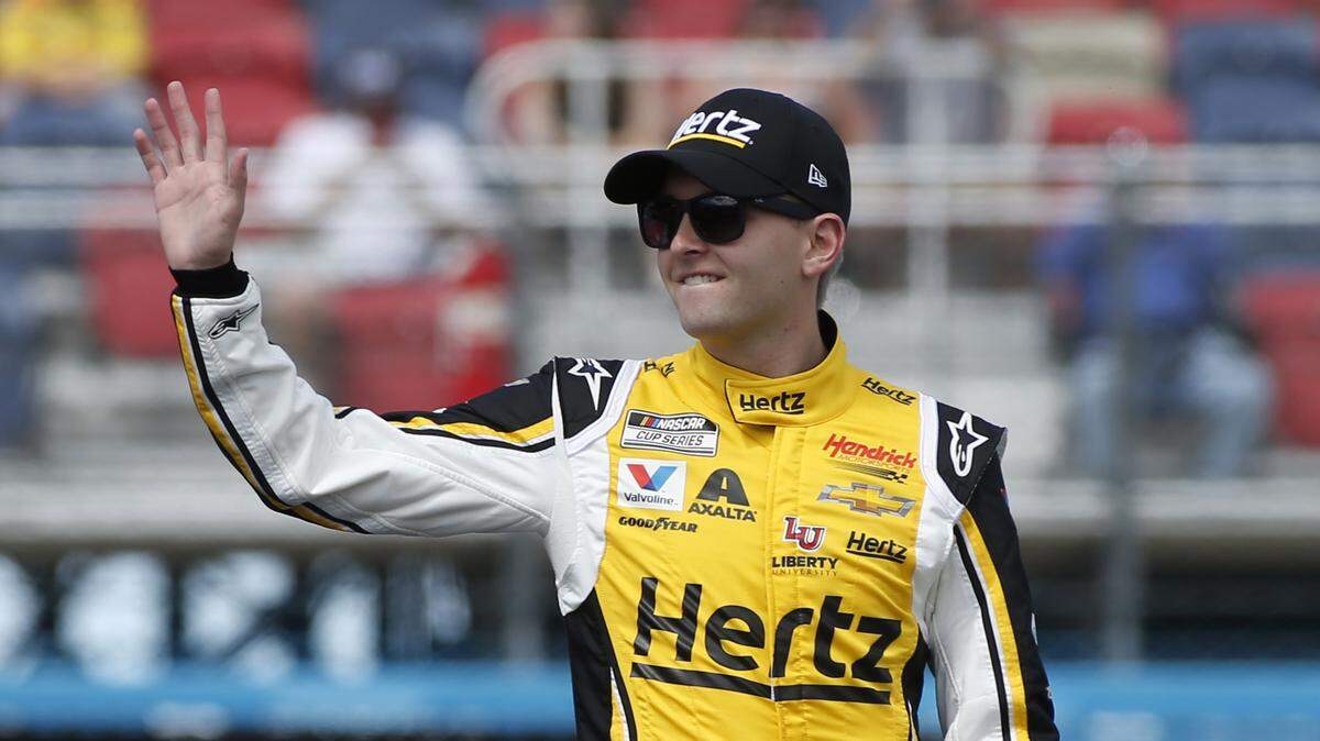 William Byron waves to fans during driver introductions prior to the NASCAR Cup Series auto race at Phoenix Raceway, Sunday, March 8, 2020, in Avondale, Ariz. (AP Photo/Ralph Freso)