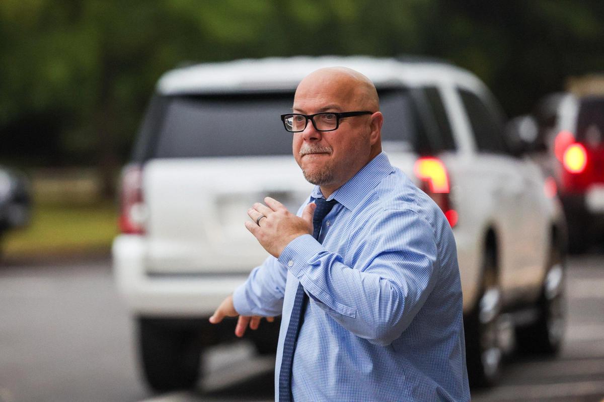 Principal Ernest Marcello directs traffic for car drop-offs for the first day of school at Waxhaw Elementary School on Monday, August 28, 2023.