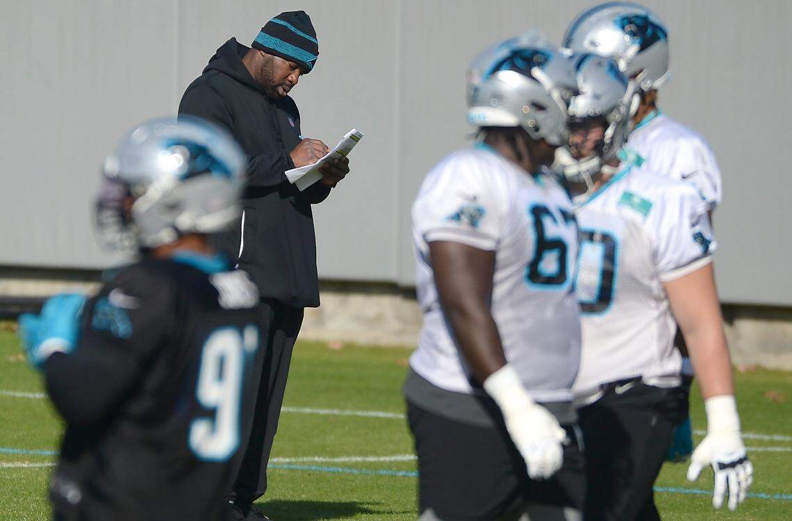 Carolina Panthers offensive coordinator Jeff Nixon, left, looks over his notes during practice on Wednesday, December 15, 2021.