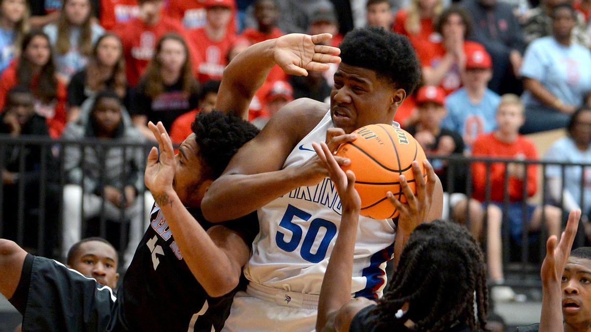 North Meck’s Jeremy Gregory, center, maintains control of a rebound against Olympic during first half action in the Men’s 4A Western Regional game at Lenoir-Rhyne in Hickory, NC on Saturday, March 7, 2020. North Meck defeated Olympic 86- 78.