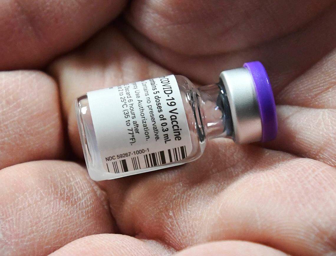 Novant Health’s Brad Petersen holds a vial of Covid 19 vaccine at Novant Health Presbyterian Medical Center after it was delivered on Thursday, December 17, 2020.