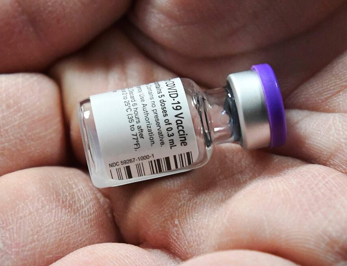 Novant Health’s Brad Petersen holds a vial of Covid 19 vaccine at Novant Health Presbyterian Medical Center after it was delivered on Thursday, December 17, 2020.