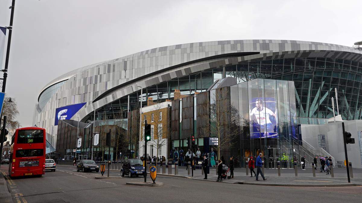 People walk outside the new Tottenham Hotspur stadium ahead of the English Premier League soccer match betweenTottenham Hotspur and Crystal Palace, the first Premiership match at the new stadium in London, Wednesday, April 3, 2019. (AP Photo/Kirsty Wigglesworth)