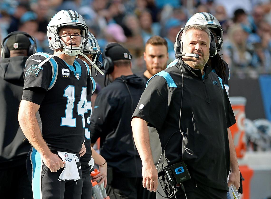 Carolina Panthers quarterback Sam Darnold, left and head coach Matt Rhule, right, watch a replay during second quarter action against the Tampa Bay Buccaneers during second quarter action on Sunday, December 26, 2021 at Bank of America Stadium in Charlotte, NC.
