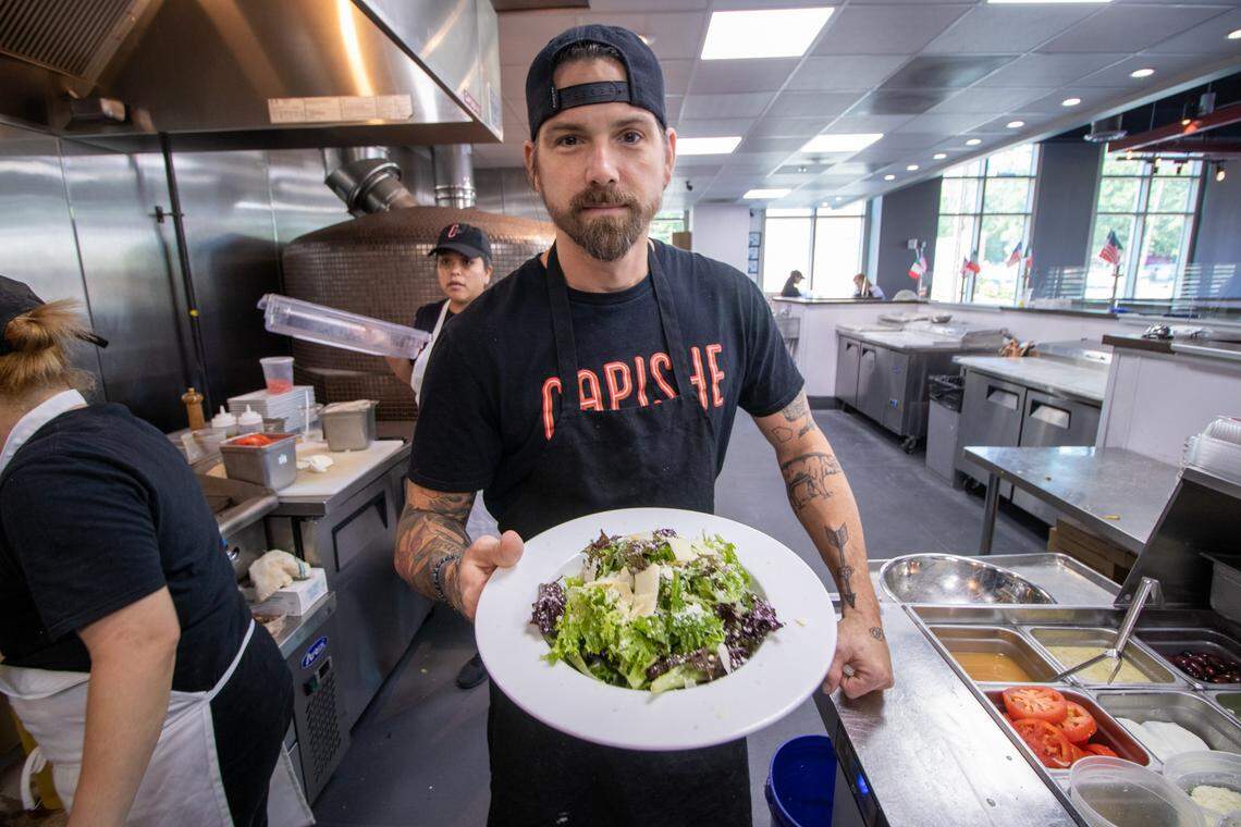 Pasta chef David Cavalier shows off an Italiano salad, made with greens, pecorino and lemon vinaigrette.