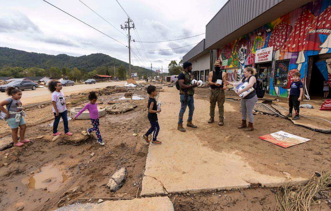 Swannanoa residents share rolls of toilet paper on Sunday, Sept. 29, 2024. The remnants of Hurricane Helene caused widespread flooding, downed trees, and power outages in western North Carolina.