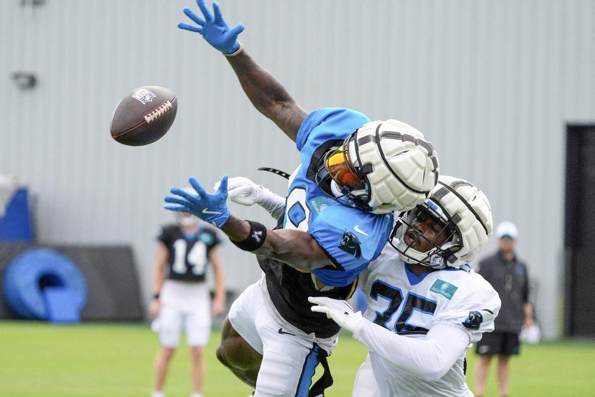 Jul 30, 2024; Charlotte, NC, USA; Carolina Panthers wide receiver David Moore (83) reaches out for a catch against cornerback Kiondre Thomas (35) during training camp at Carolina Panthers Practice Fields. Mandatory Credit: Jim Dedmon-USA TODAY Sports