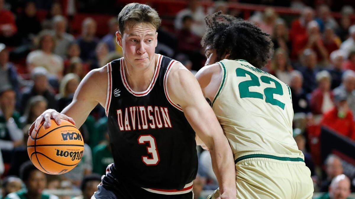 Davidson Wildcats forward Sam Mennenga (3) dribbles around Charlotte 49ers forward Josh Aldrich (22) during a game at Belk Arena in Davidson, N.C., Tuesday, Nov. 29, 2022.