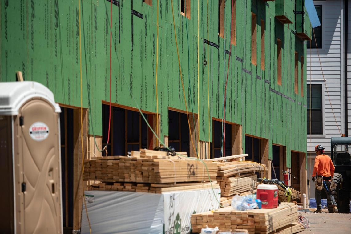 A construction worker returns to a condominium complex being built on McClintock Road in Charlotte, N.C., on Thursday, July 23, 2020.