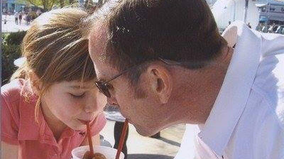 Grace Burud and her dad share a Coke slushy at Universal Studios in 2006.