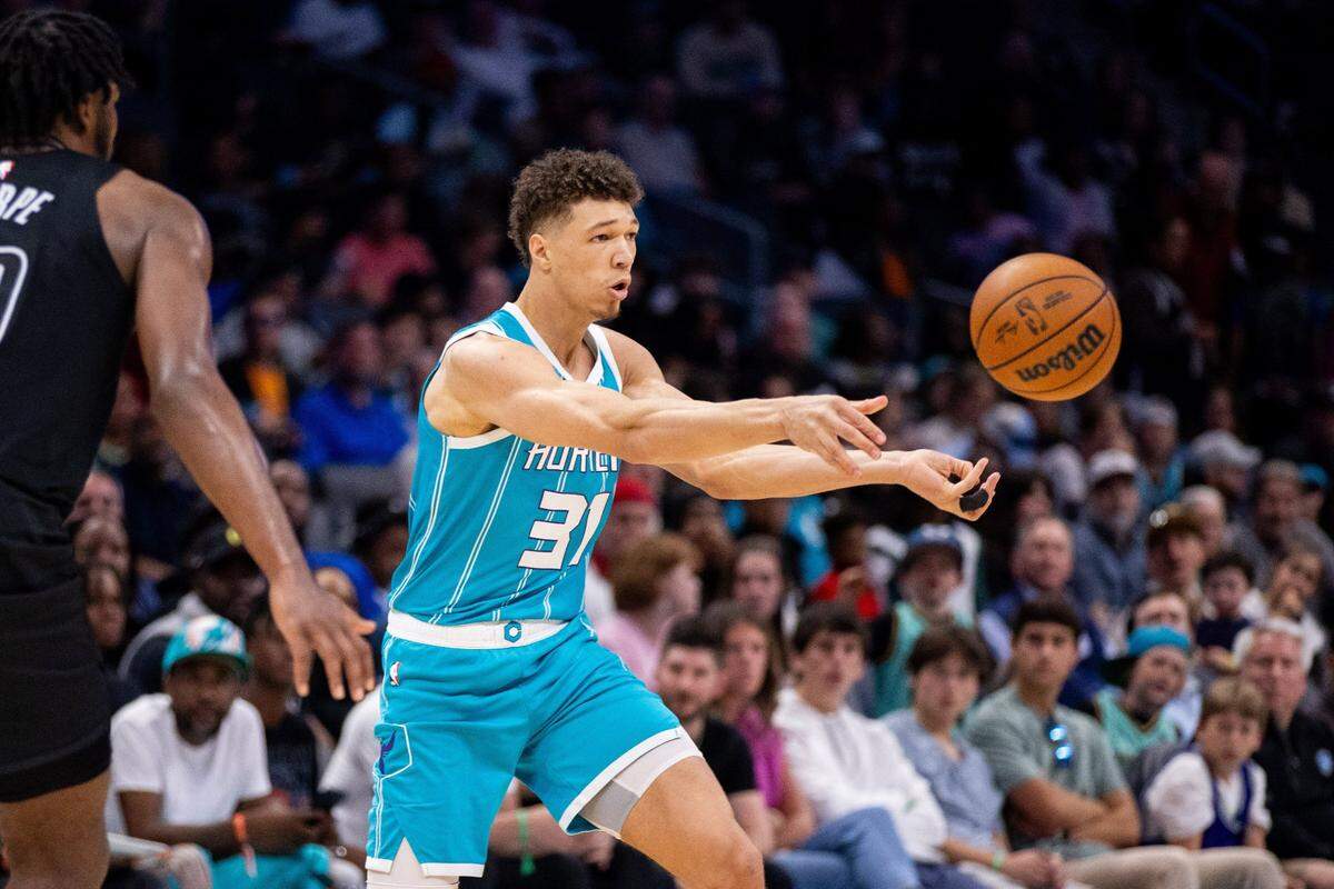 Mar 8, 2025; Charlotte, North Carolina, USA; Charlotte Hornets forward Tidjane Salaun (31) passes the ball away during the fourth quarter against the Brooklyn Nets at Spectrum Center. Mandatory Credit: Scott Kinser-Imagn Images