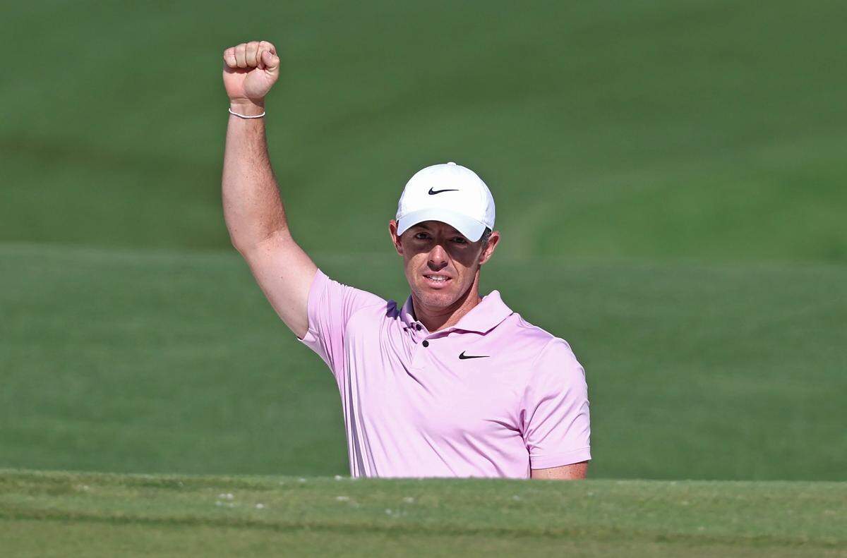 Rory McIlroy raises his fist in celebration after chipping his ball into the cup from a sand trap at the 15th green during the final round of the Wells Fargo Championship at Quail Hollow Club in Charlotte, NC on Sunday, May 12, 2024. McIlroy sank the chip to eagle the hole. McIlroy won the Wells Fargo Championship at -17.