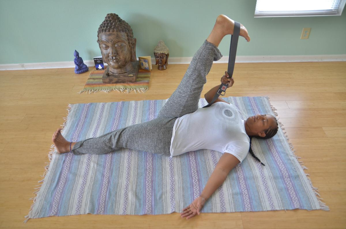Yoga teacher Keisha Battles demonstrates a hamstring and calf stretch often practiced in yoga classes.